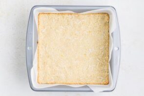 Baked coconut crust in a square baking dish.