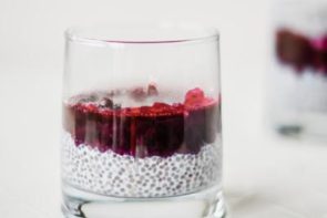 a layer of purple chia pudding with a layer of blueberry sauce on top