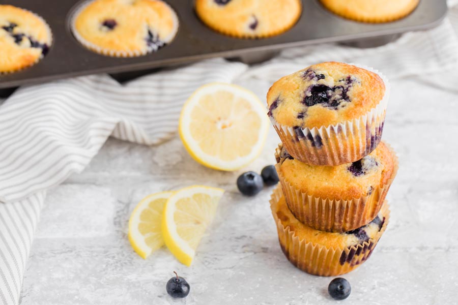 a stack of muffins in front of a muffin pan