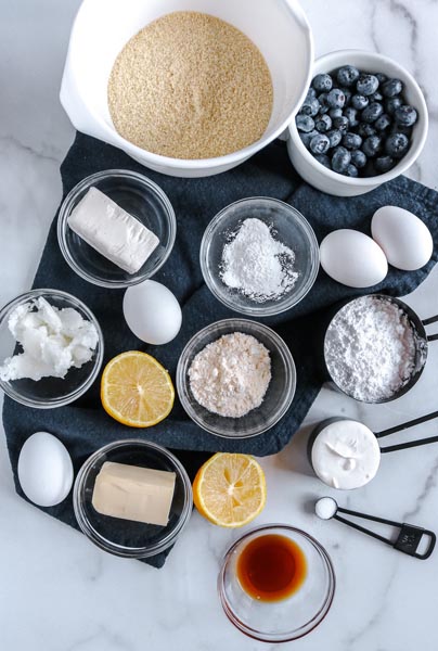 Ingredients for blueberry muffins in small bowls.