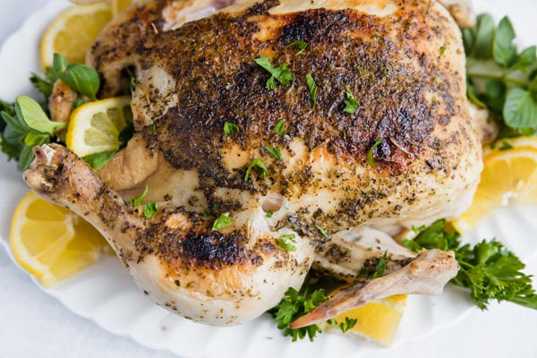 closeup overhead view of a whole rotisserie chicken with crispy golden brown skin