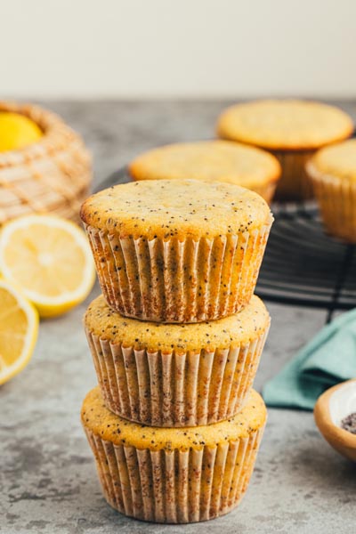 A stack of lemon poppyseed muffins baked in liners.