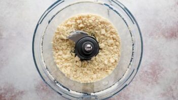 Coarse crumbled texture of butter cut into dry ingredients in a food processor.