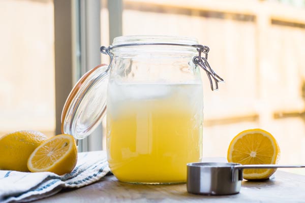 a big mason jar with fresh lemonade inside
