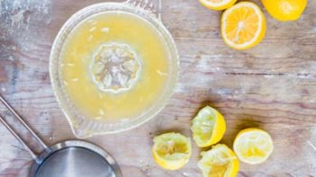 a citrus squeeze, sitting on a table with fresh lemon juice inside