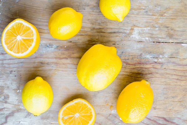 whole lemons on a cutting board