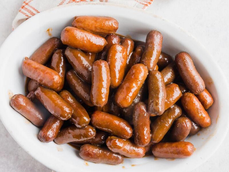 Cocktail sausages covered in bbq sauce in a bowl.