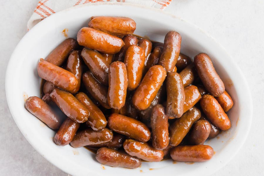 Cocktail sausages covered in bbq sauce in a bowl.