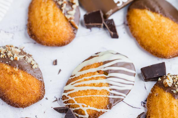 white chocolate striped over a madeleine cookie