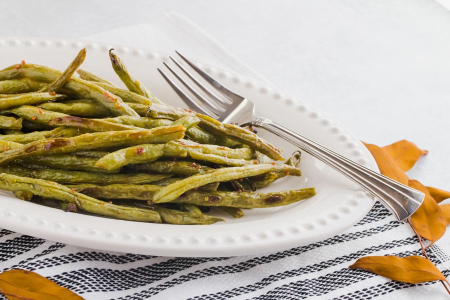 plate of keto green beans coated with maple and mustard