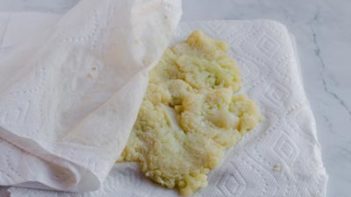 squeezing fluid out of cauliflower florets with paper towel