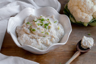 scooping out keto mashed cauliflower