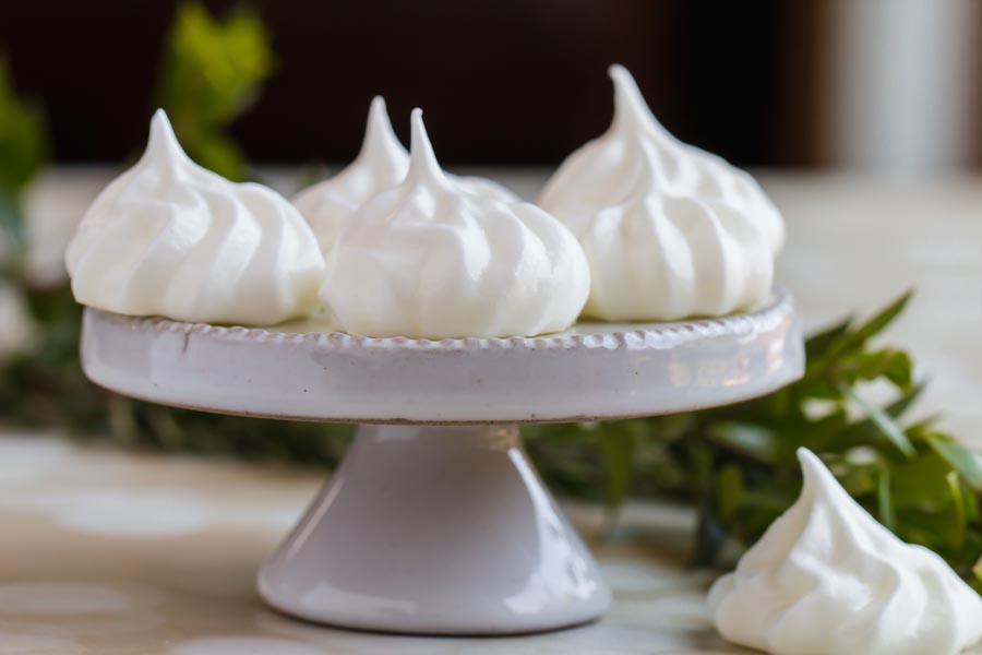 airy and shiny cookies on a cake stand