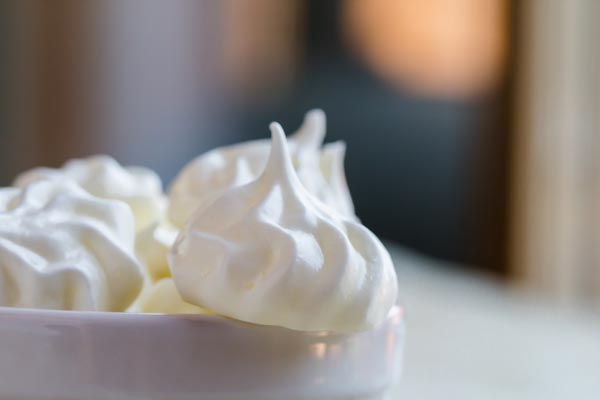 a small glossy meringue cookie on the edge
