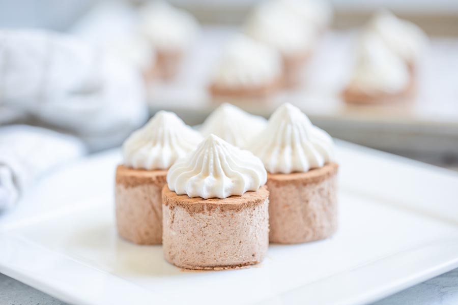 three chocolate fat bombs on a white plate