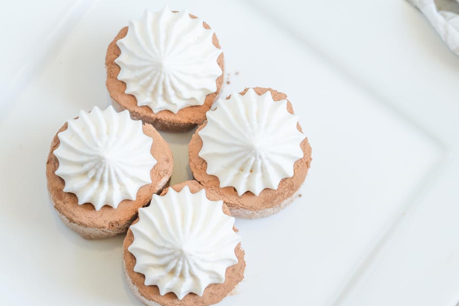 chocolate fat bombs topped with piped whipped cream