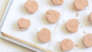 fat bombs dusted with cocoa powder on a baking tray