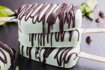 a stack of mint chip popsicles with chocolate on them