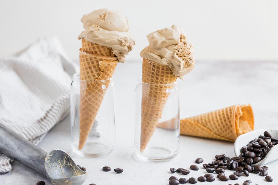 two double scoop cones in a cup with espresso beans below