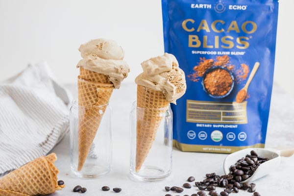 two ice cream cones in clear cups with a bag of cacao bliss behind