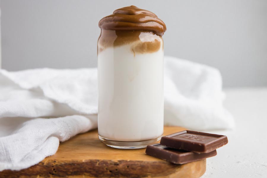 low carb whipped coffee with chocolate flavor in a glass with layered cream