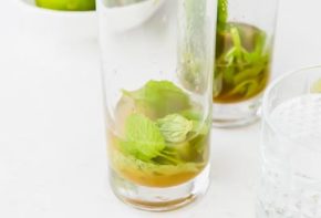 mint leaves at the bottom of a high ball glass