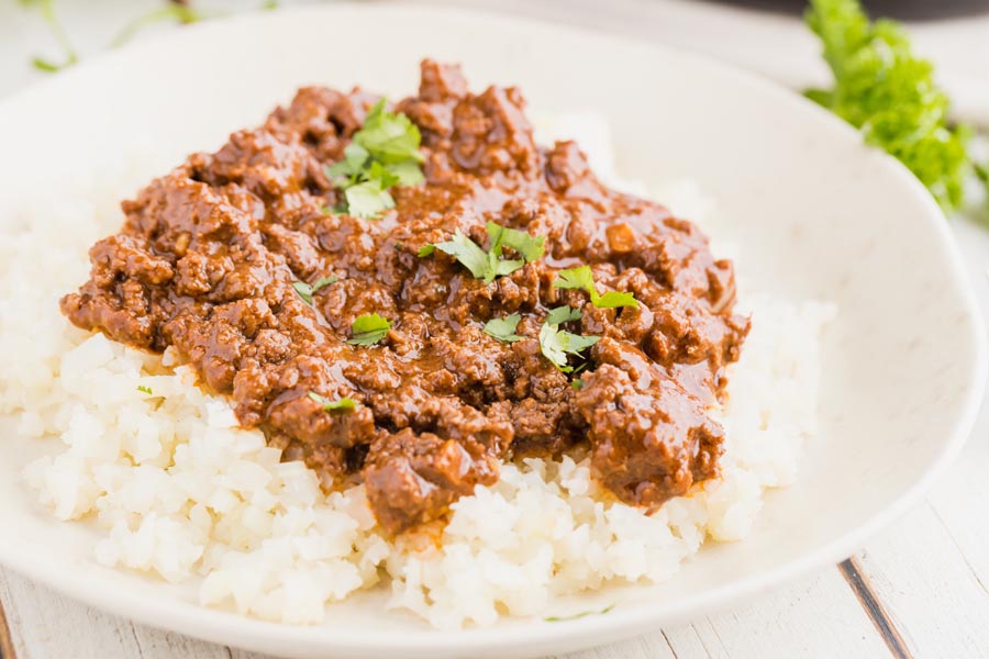 mole beef on a plate over keto rice