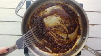 stirring spices in a skillet to bloom the aroma