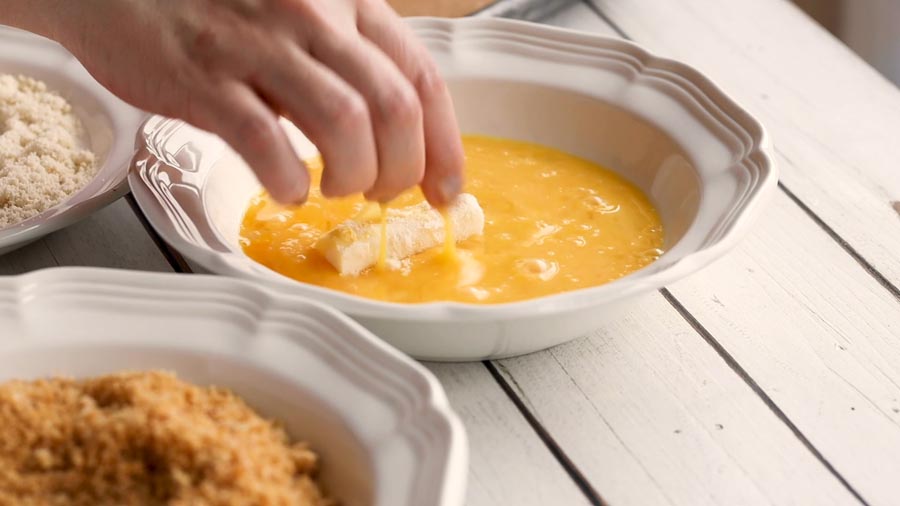 dipping mozzarella cheese in egg wash