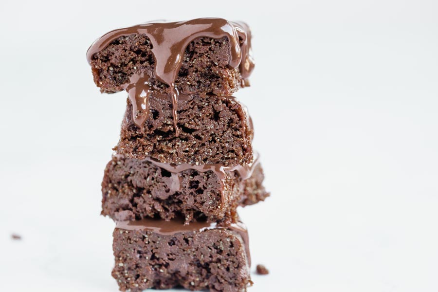 chocolate dripping down a stack of brownies