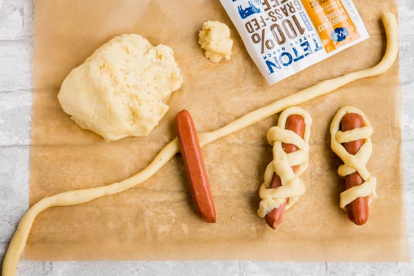 wrapping hot dogs with keto fathead dough to look like a mummy