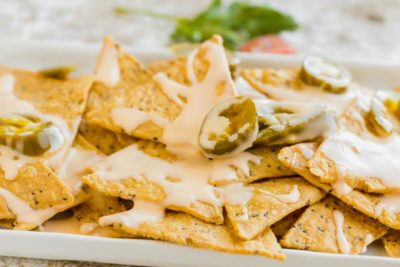 a plate of nachos with jalapenos