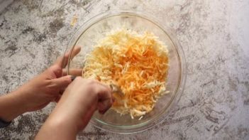 mixing shredded cheese blend with a spoon