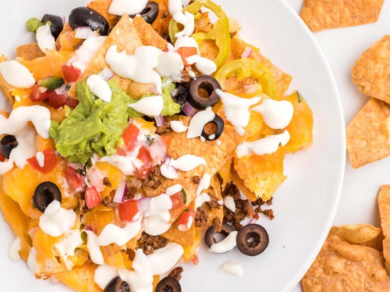 Beef nachos topped with cheese sauce, pico de gallo, red onion, olives and guacamole.