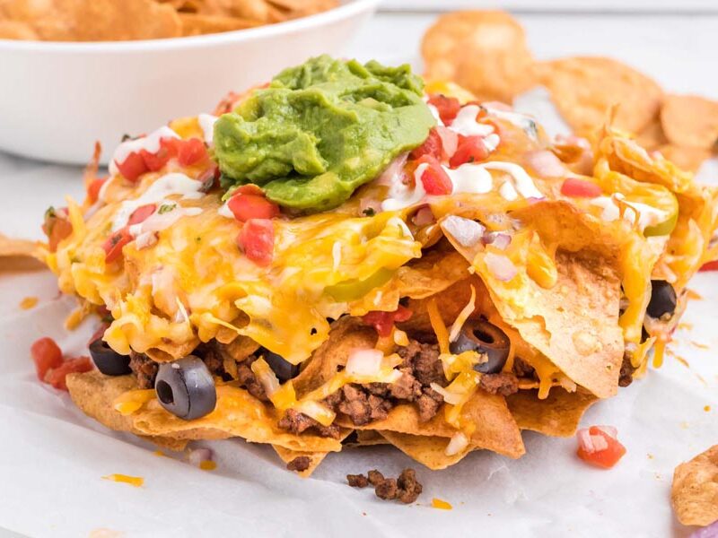Layers of crispy chips topped with melted cheese, seasoned beef, guacamole and salsa.