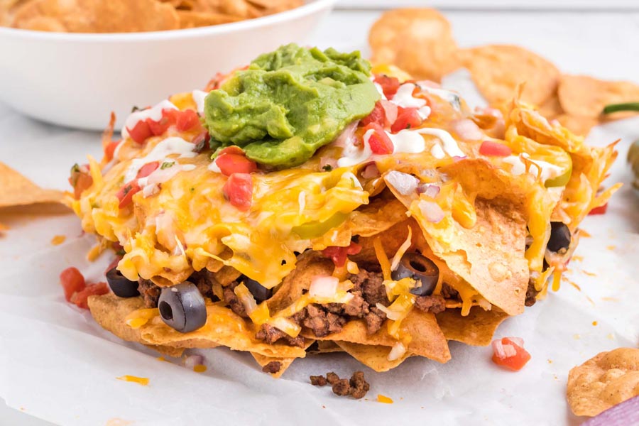 Layers of crispy chips topped with melted cheese, seasoned beef, guacamole and salsa.