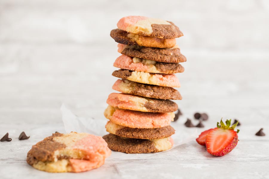 a stack of keto cookies with chocolate chips and strawberries near