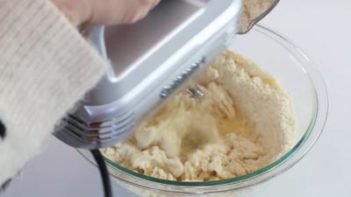 mixing the cookie dough with an electric mixer.