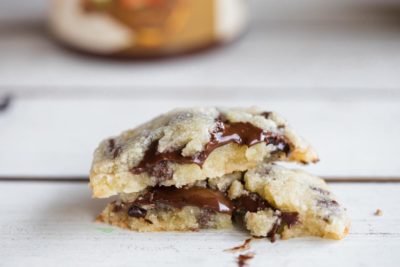 two keto cookies filled with hazelnut cream stacked up