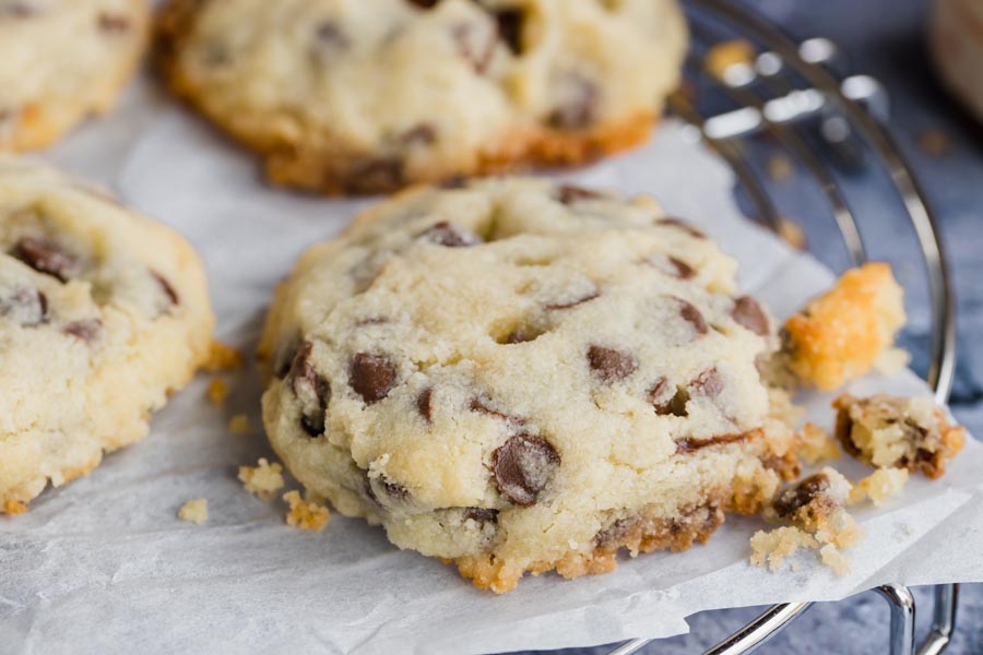 four chocolate chip cookies on a wire rack