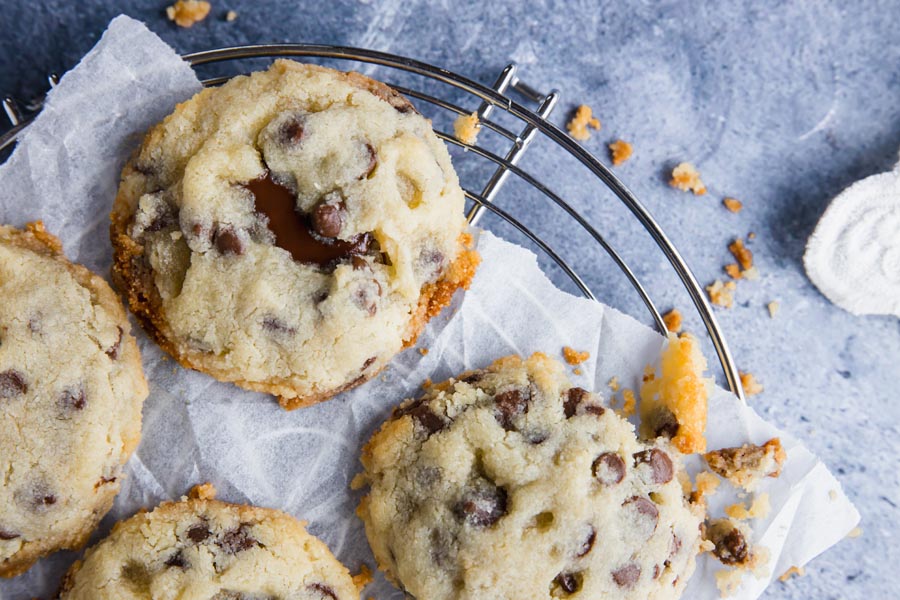 four chocolate chip keto cookies with melted chocolate inside