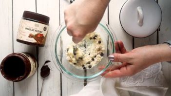 stirring a chocolate chip cookie dough mixture