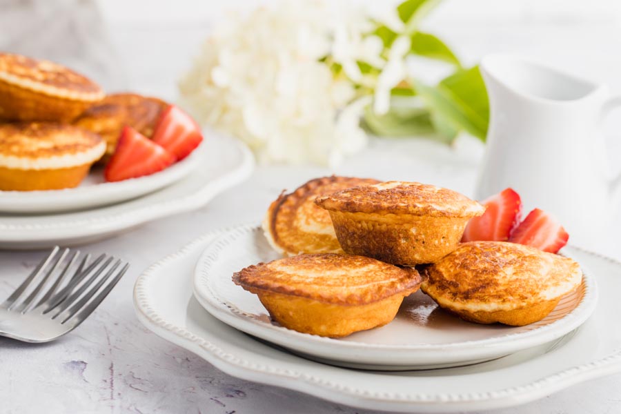 a stack of pancake pies with one sliced in half to show the filling