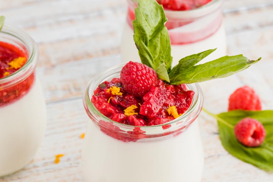 velvet smooth panna cotta in a jar with crushed berries