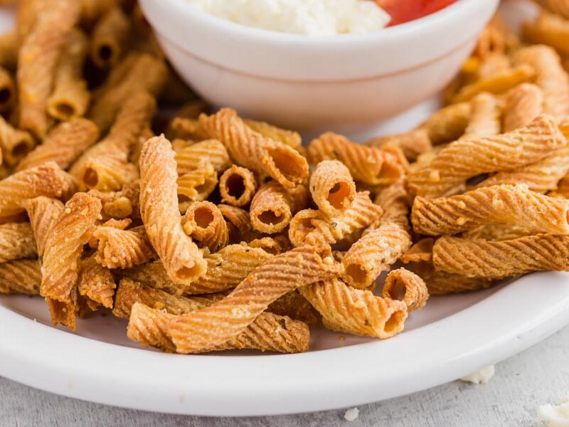close up of pasta chips with parmesan cheese baked on them