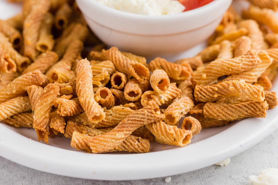 close up of pasta chips with parmesan cheese baked on them