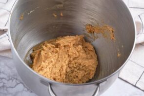 A ball of peanut butter cookie down in a bowl.