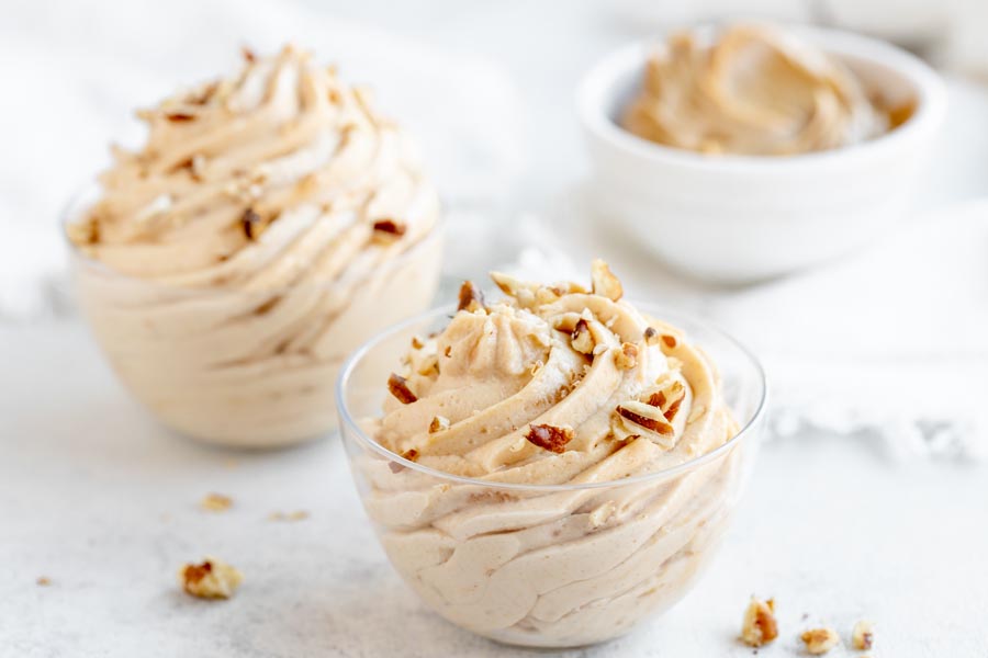 crushed peanuts on top of a swirled peanut butter mousse