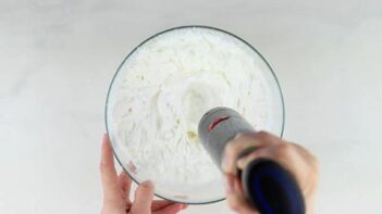 mixing whipped cream with a handheld mixer