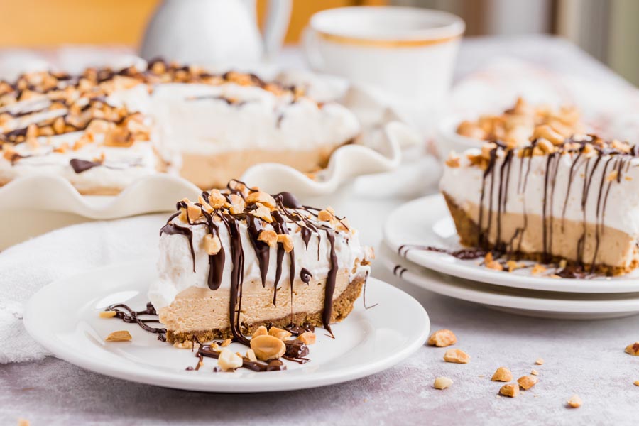 two slices of peanut butter pie on a plate with chocolate drizzled on top